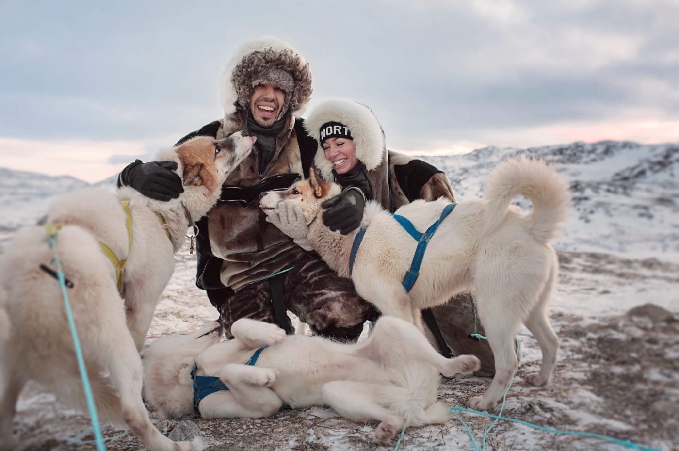 Canadian social media influencers Siya Zarrabi and Kristen Sarah being greated by sled dogs near Ilulissat in Greenland. Photo by Rebecca Gustafsson