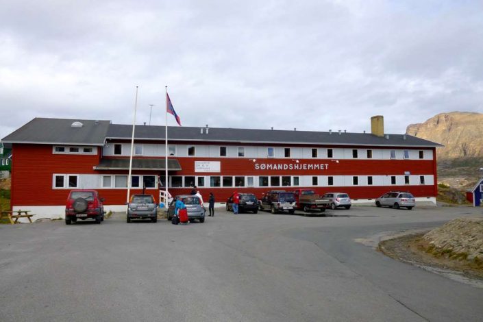 Frontal view of The Sisimiut Seamen's Home and parking area. Photo by Hotel Sømandshjemmet, Visit Greenland