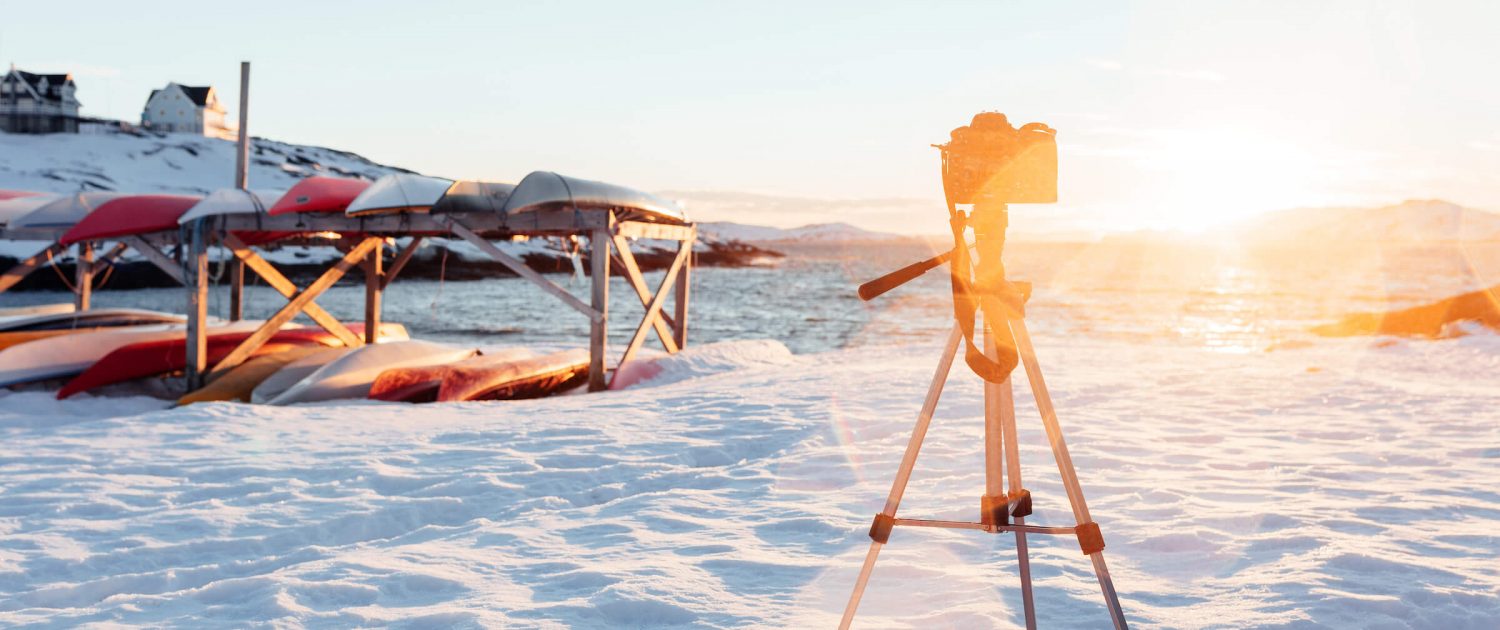Camera on a tripod taking a timelapse of a sunset in Nuuk in Greenland. Photo by Rebecca Gustafsson
