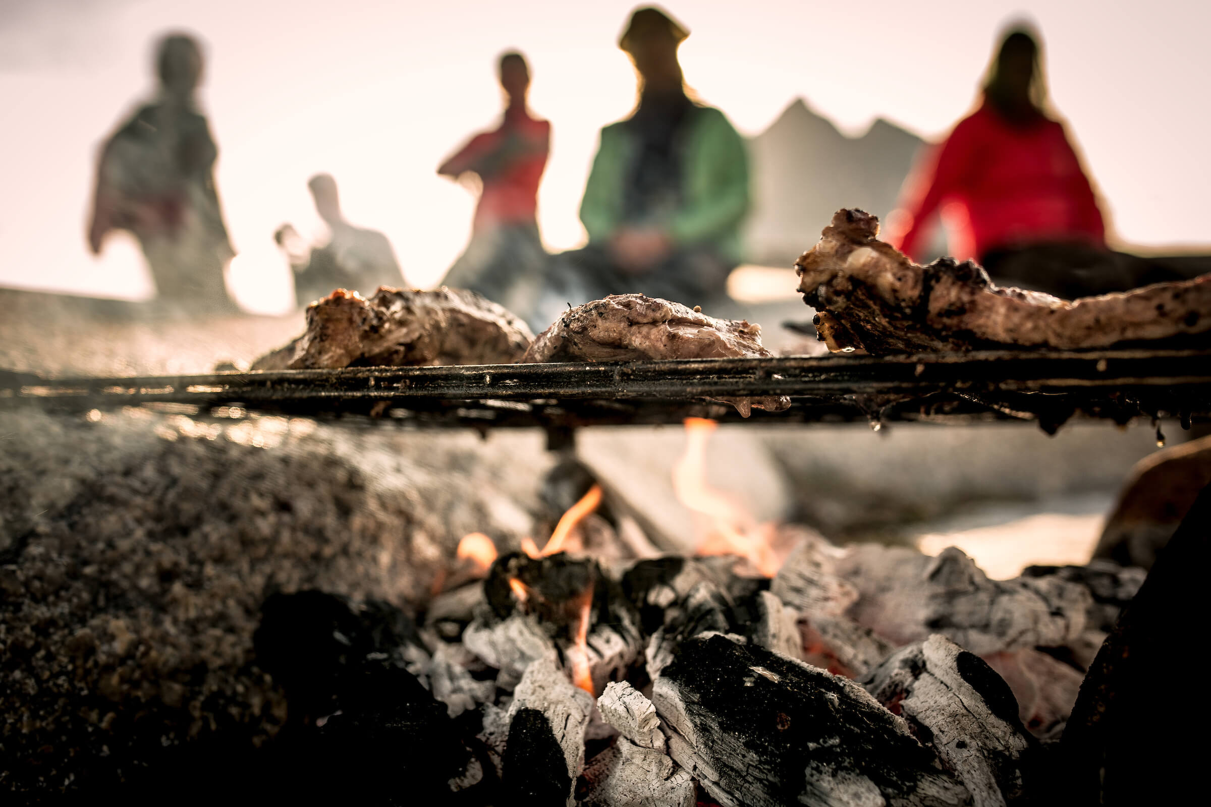 Food roasting over a fire in East Greenland. Photo by Mads Pihl