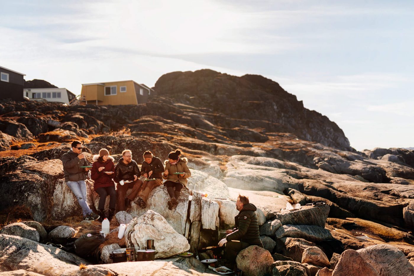 Group of friends barbequing on the beach of Inuk Hostels in Nuuk in Greenland. By Rebecca Gustafsson
