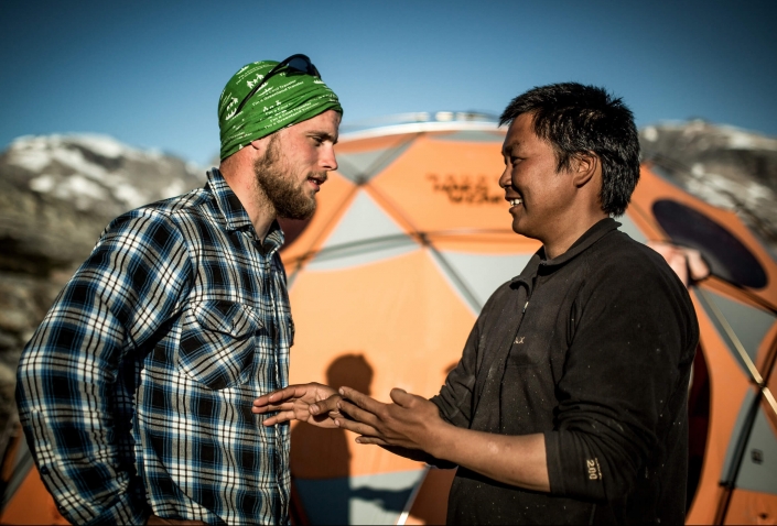 A Greenland Travel hiking guide and a local camp manager from East Greenland discussing the pronounciation of East Greenlandic words. Photo by Mads Pihl, Visit Greenland