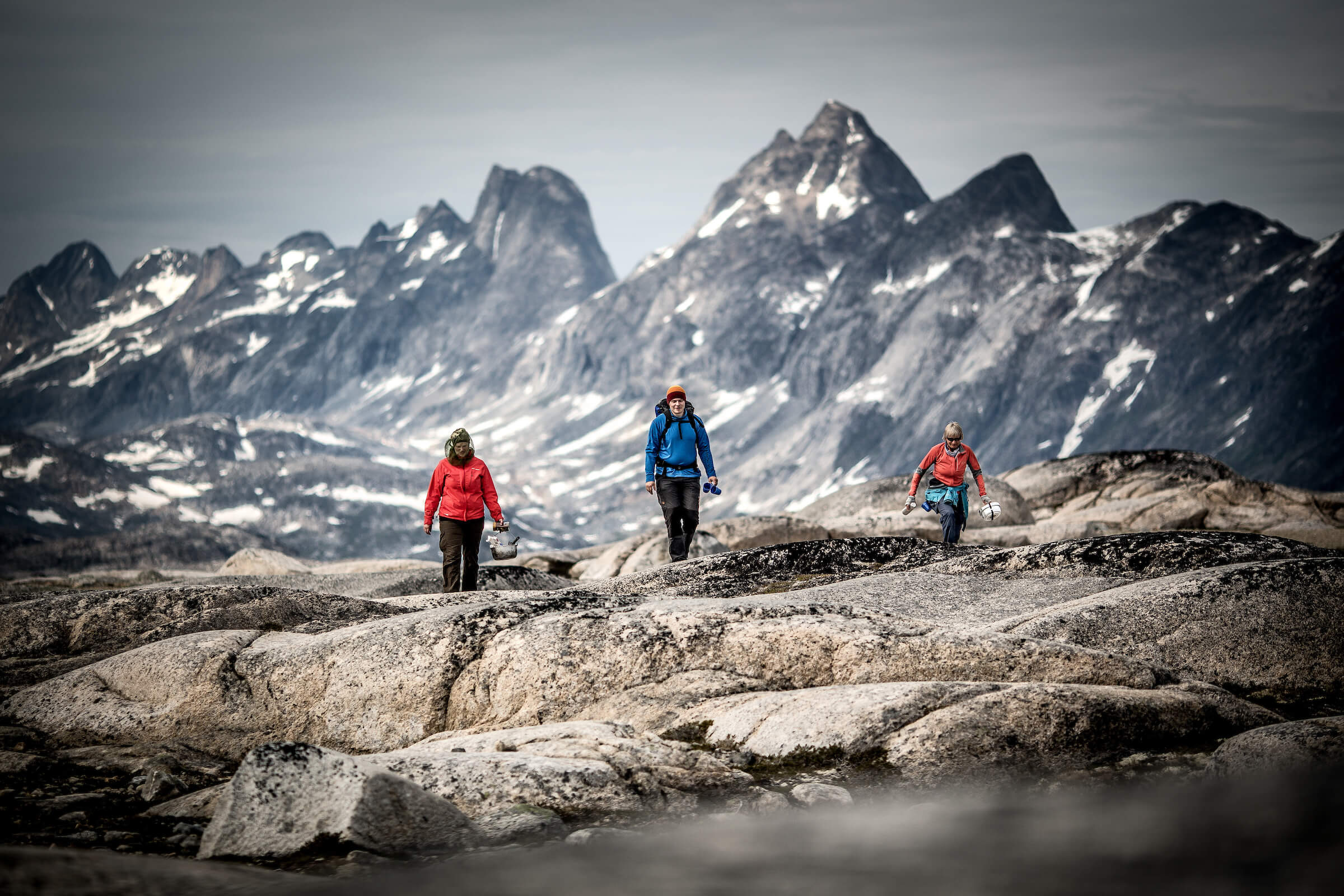Three hikers in the mountains near Qernertivartivit not far from Kulusuk in East Greenland. Photo by Mads Pihl - Visit Greenland