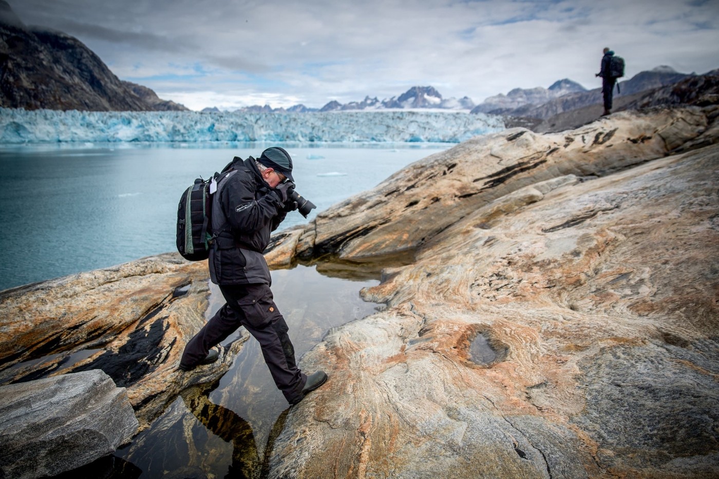 A photographer focusing on rock lines and details near the Knud Rasmussen glacier in East Greenland. By Mads Pihl