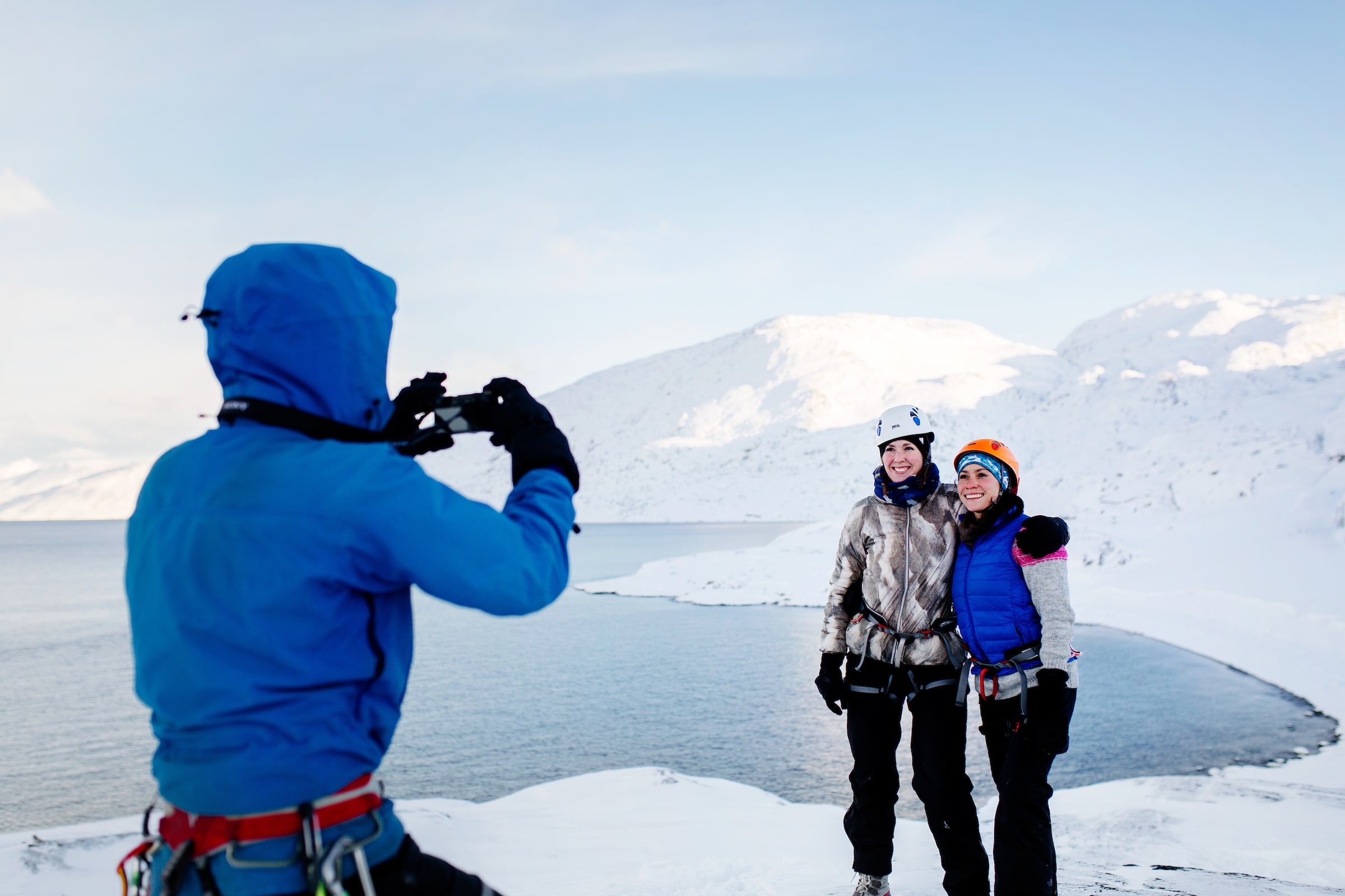 Mountain guide Marc Carreras taking photos of tourist on a winter hike in Nuuk in Greenland. By Rebecca Gustafsson
