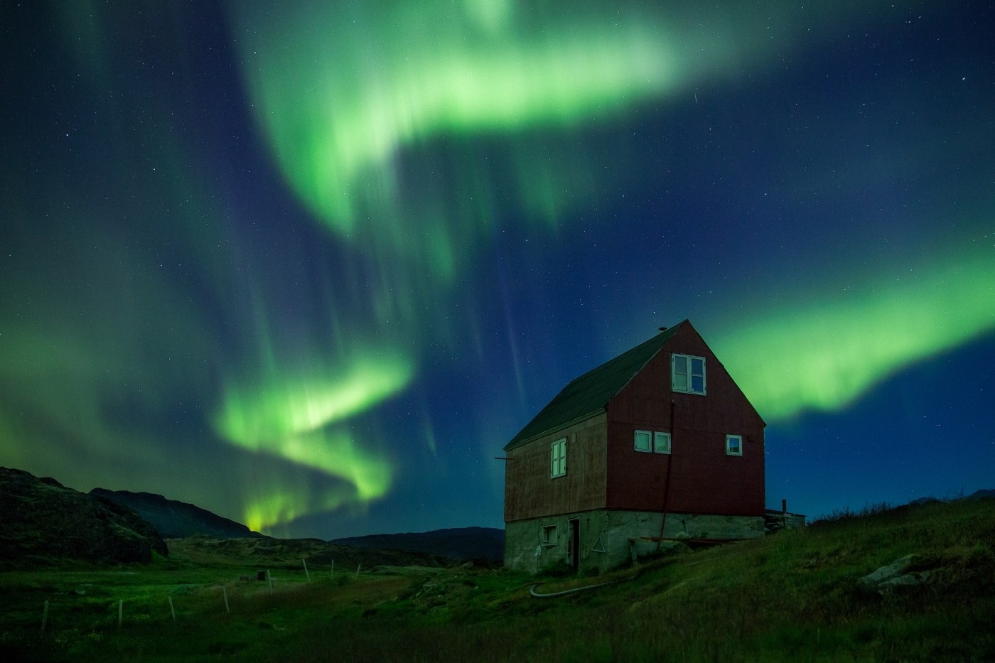 Northern lights over Sermilik Hostel at Tasiusaq sheep farm in South Greenland. By Mads Pihl