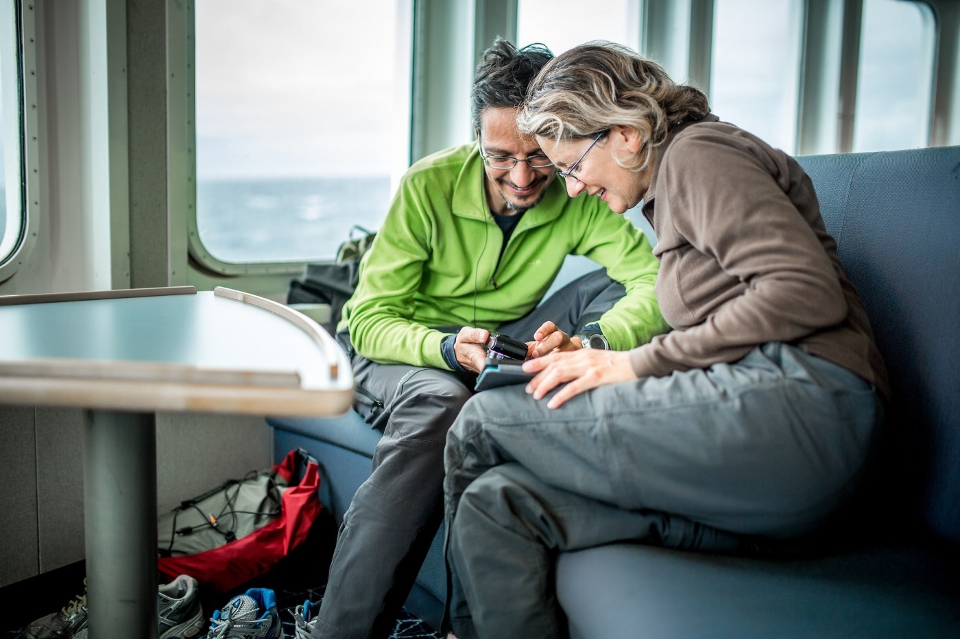 Two guests in the lounge on Sarfaq Ittuk in Greenland. Photo by Mads Pihl - Visit Greenland