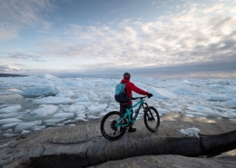 Chris Winter enjoying one of the most spectacular views you can get to by mountain bike. Ilulissat Icefjord, Ilulissat, North Greenland. Photo by Ben Haggar - Visit Greenland
