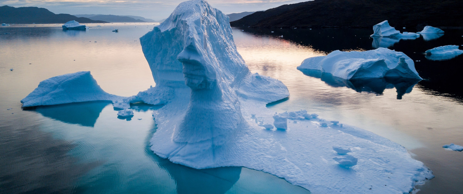 Sunset & Icebergs in Clear Water. Photo - Aningaaq R. Carlsen, Visit Greenland