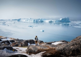 Person admiring the beautiful view of icefjord in Ilulissat. Photo by Alex Savu - Visit Greenland