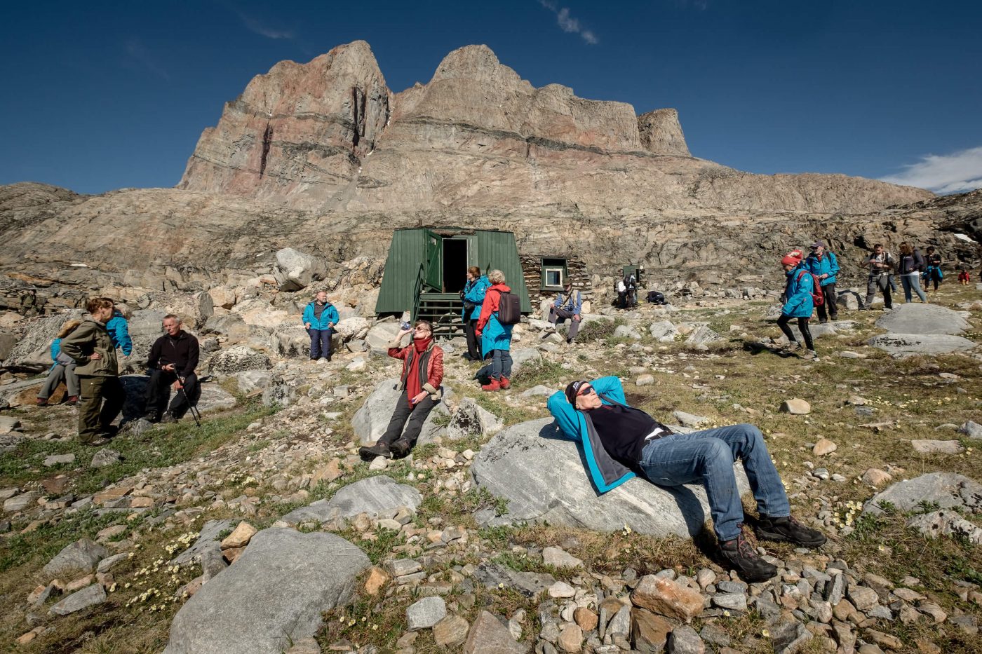 Cruise guests from MS Fram relaxing outside the Santa Claus cabin in Uummannaq in Greenland. By Mads Pihl