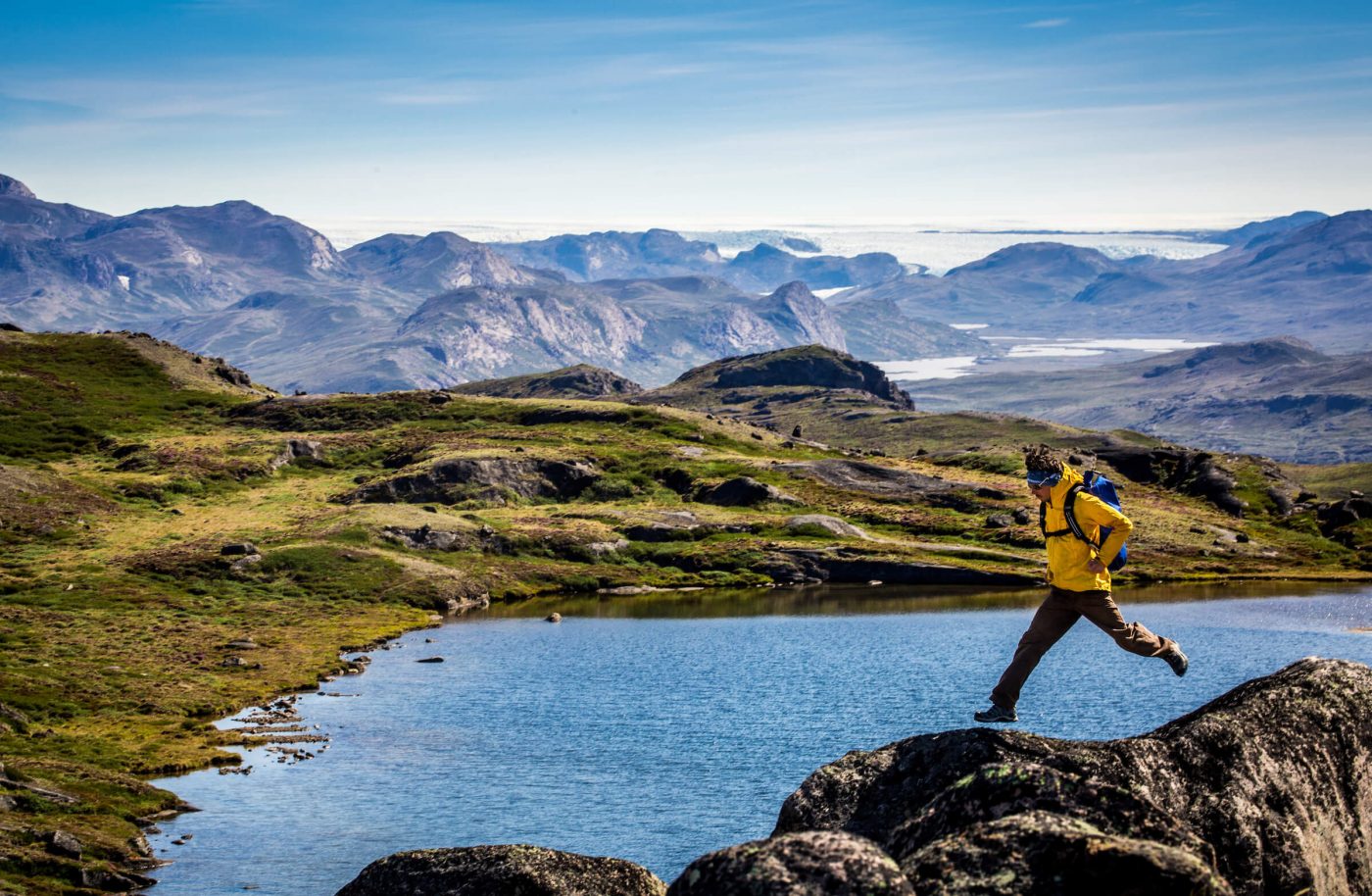 Enthusiastic hiker having fun near the Greenland Ice Sheet along the Arctic Circle. By Raven Eye Photography