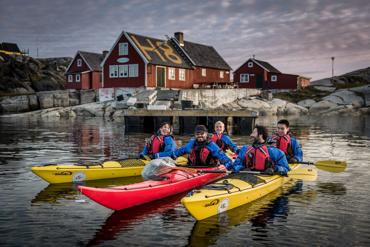Kayakers from PGI Greenland in front of Restaurant H8 in Oqaatsut in Greenland. Photo by Mads Pihl