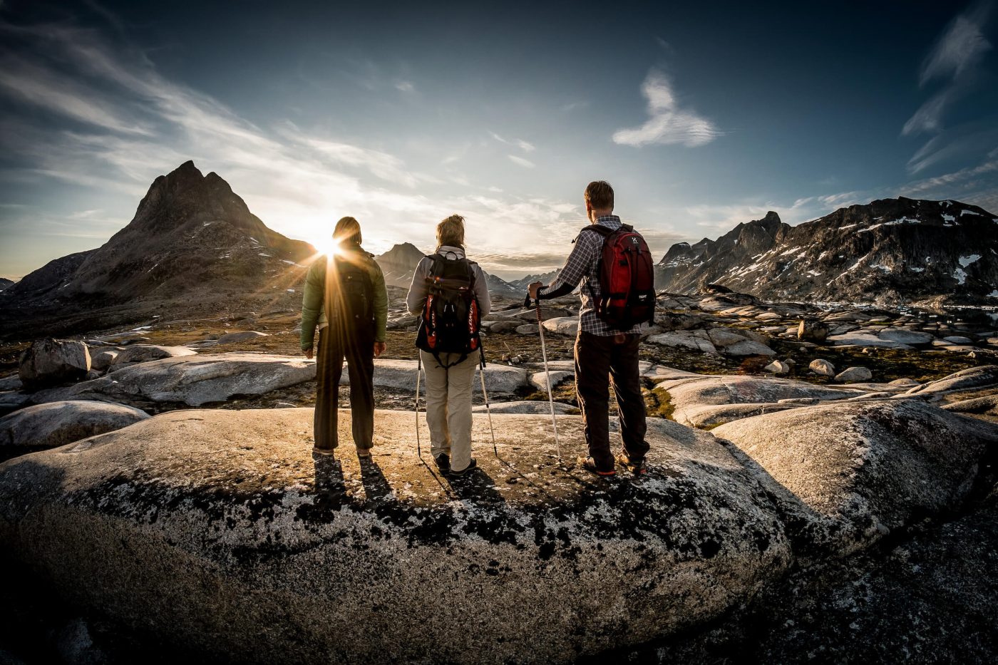 Three hikers in the setting sun near Qernertivartivit in East Greenland, by Mads Pihl